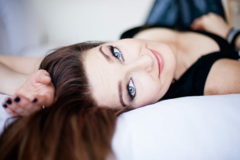 Sagarra lying on the bed looking at the camera
