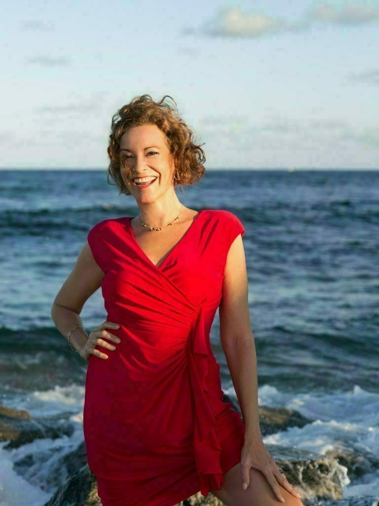 Lourdes Starshower in a red dress at the sea side