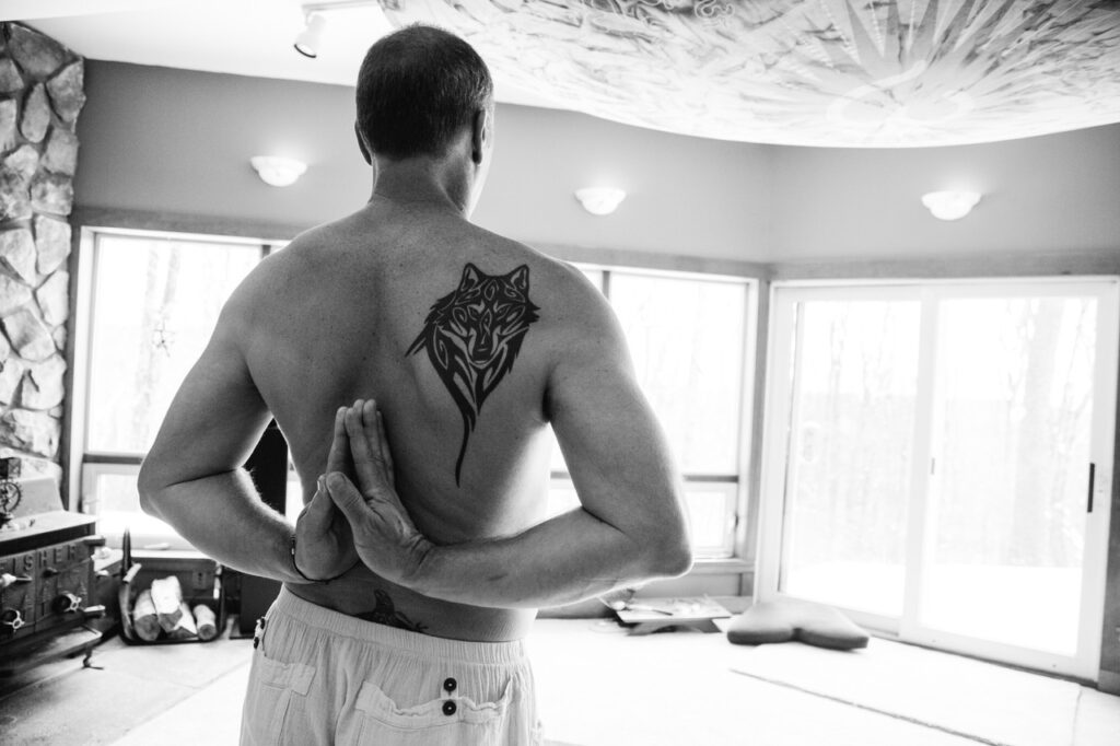 Christian without a shirt from the back.