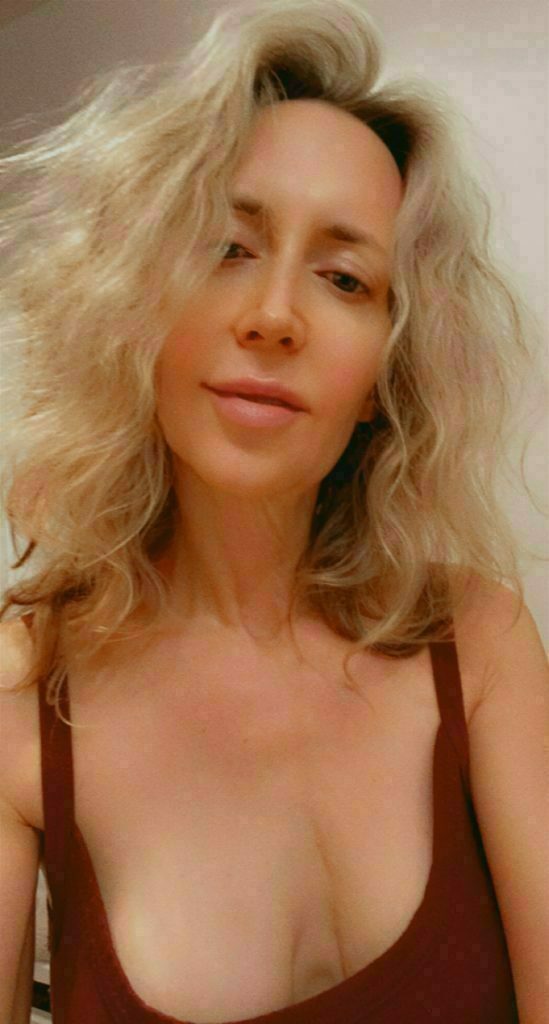 Laurie with long blond hair showcasing Sensual Healing Touch