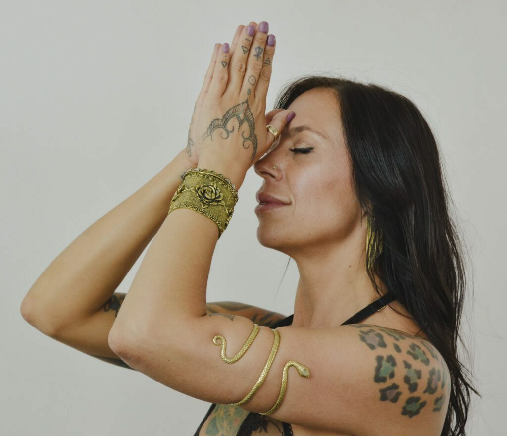 Praying with with her hands to her forehead