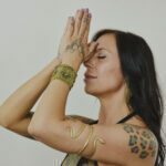 Praying with with her hands to her forehead
