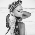 Holding a snake on the beach