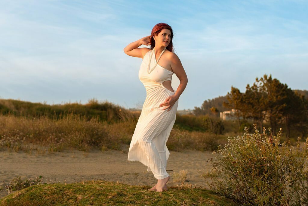 Sabrina Joy posing in a white dress