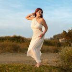 Sabrina Joy posing in a white dress