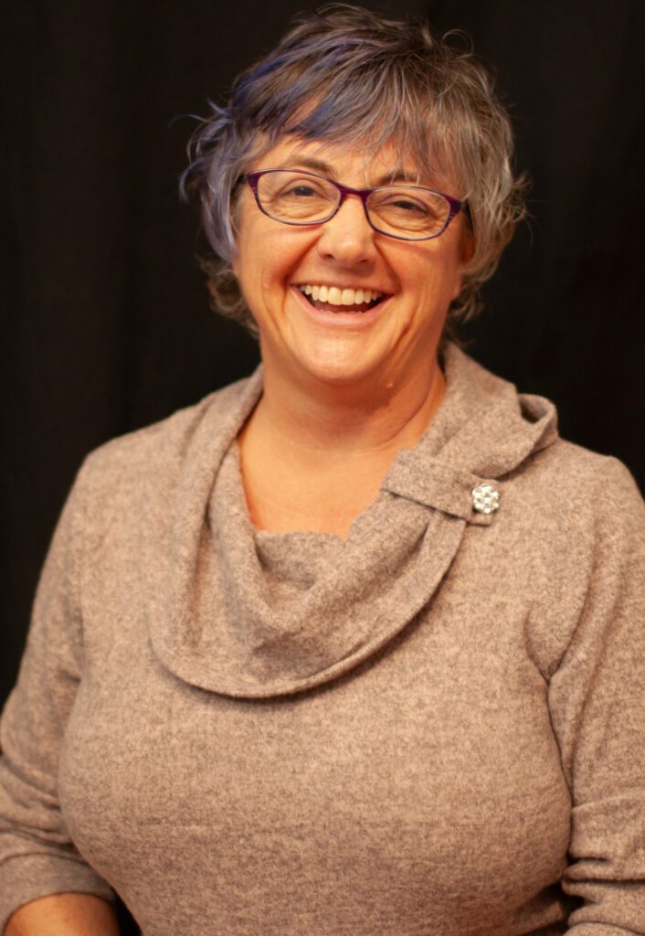 Tracy smiling looking at the camera