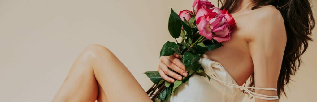 Eva holding flowers against her chest