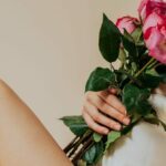 Eva holding flowers against her chest