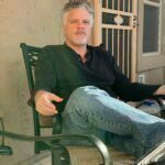Sitting on a chair looking relaxed