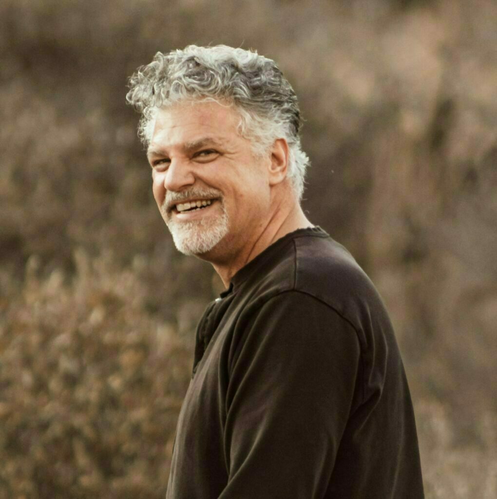 James standing in a field smiling
