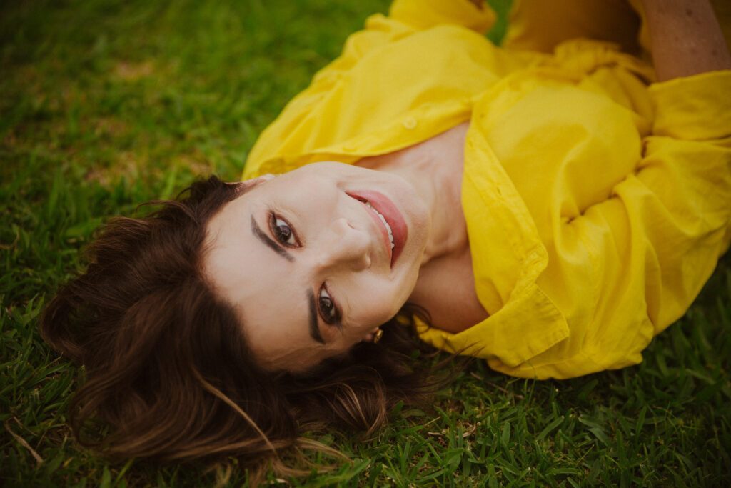Simone smiling in a yellow top