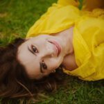 Simone smiling in a yellow top