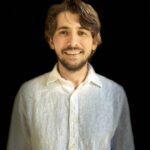 Max Kesler in a white shirt surrounded by black