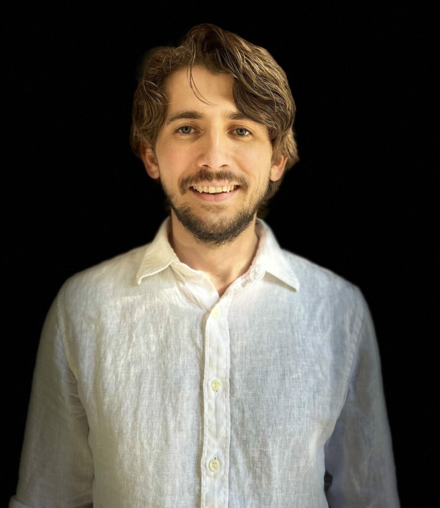 Max Kesler in a white shirt surrounded by black