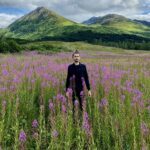 In a field with a backdrop of mountains