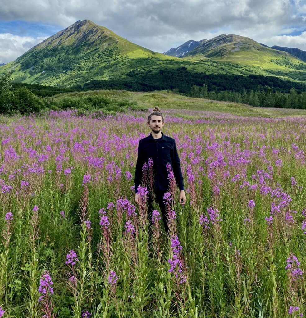 In a field with a backdrop of mountains