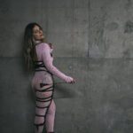 Lady M. Svarga in pink holding a crop