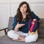 Raven on the couch pointing at a soft vagina-toy.