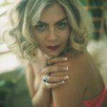 Kali in pink lingerie with an enticing gaze.