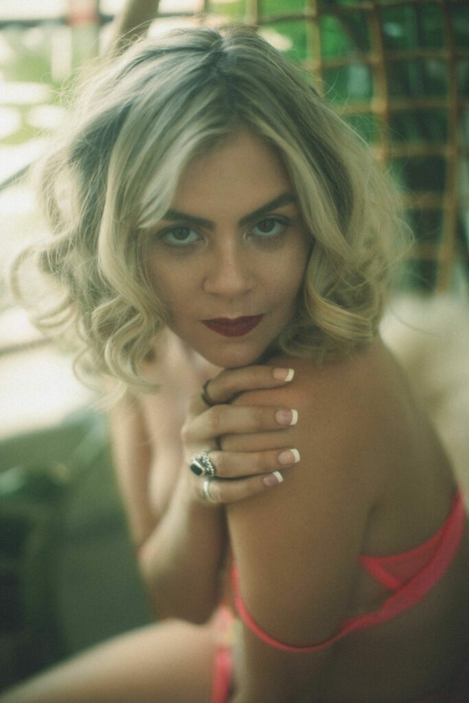 Kali in pink lingerie with an enticing gaze.