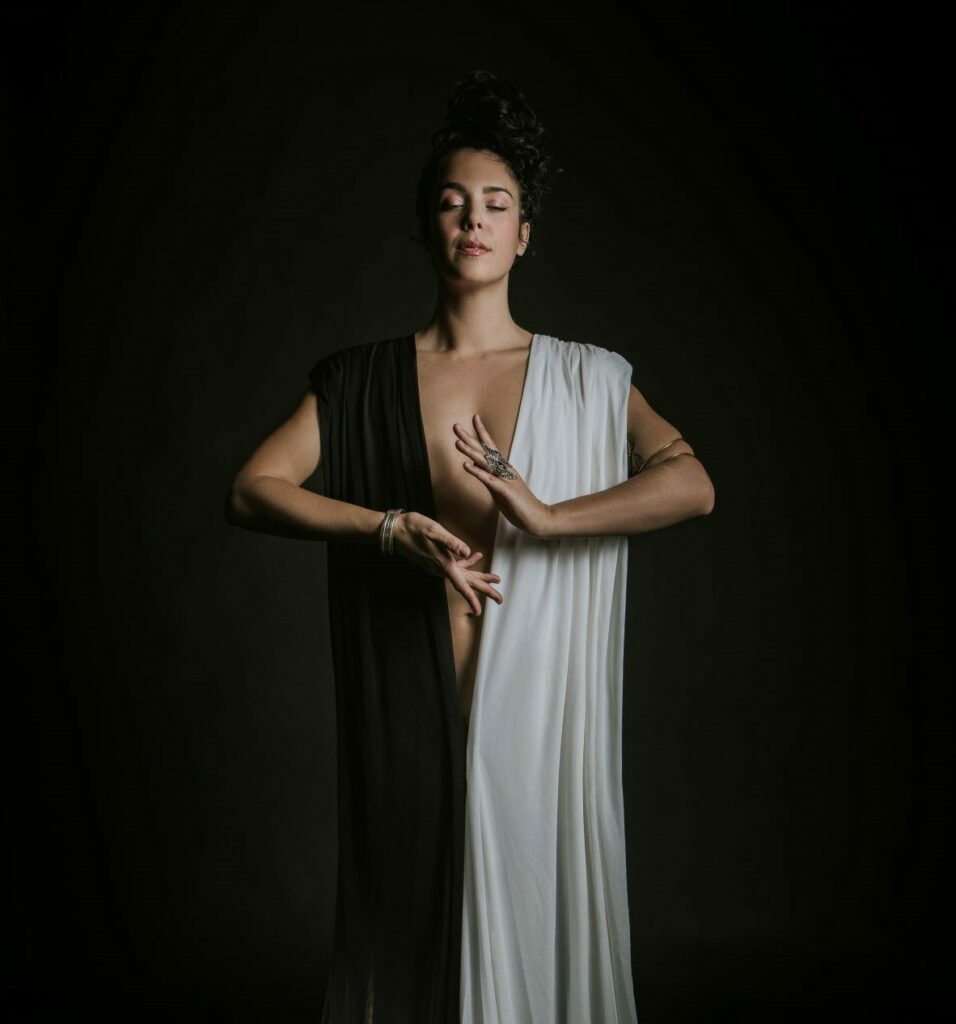 Sexual Mystic standing tall in white and black