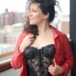 Isis Phoenix dressed in black and red