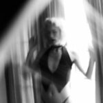 Elle standing in a window
