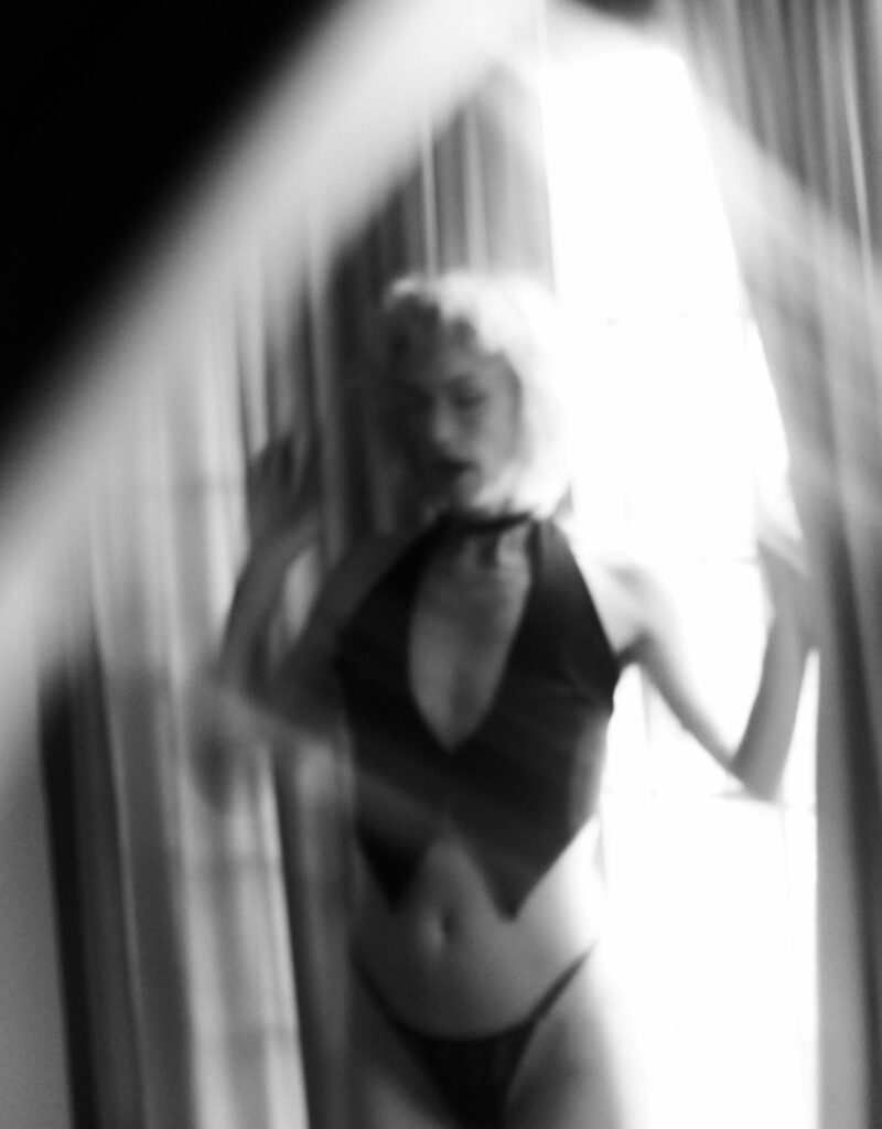Elle standing in a window