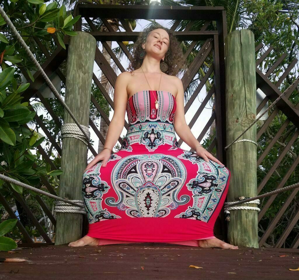 Rae Preston in a dress half squatting