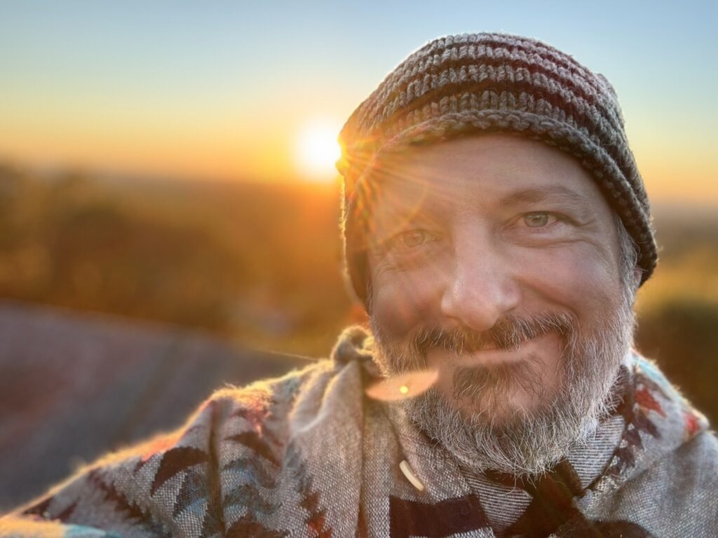 The sun rising behing Aaron