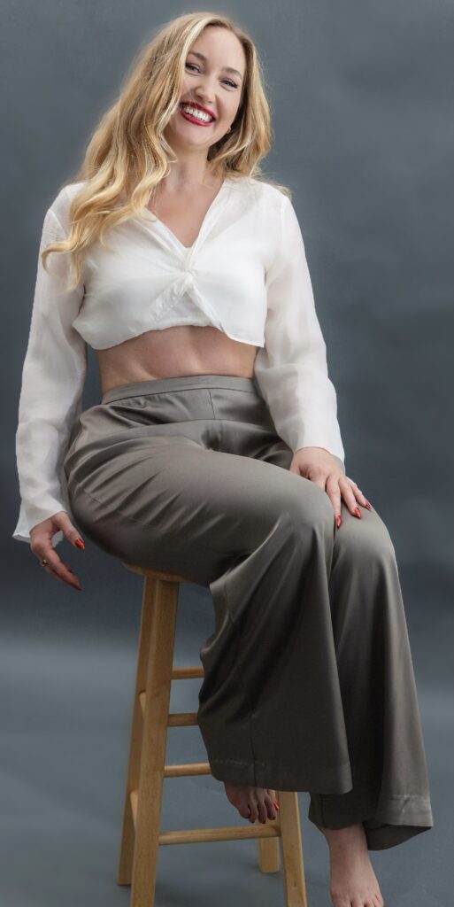 Anastasia sitting on a stool