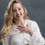 Anastasia Grace with her hand over her chest