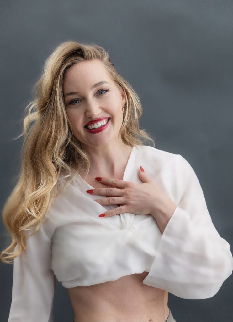 Anastasia Grace with her hand over her chest