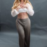 Anastasia standing with her hands over her chest