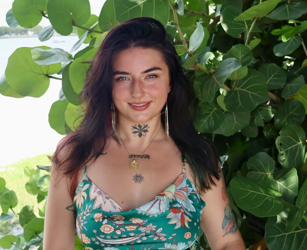 Syra near the beach under a leafy tree.