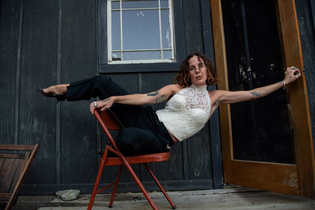 Funky shot of Calypso balancing on a chair leaning agaist a door.