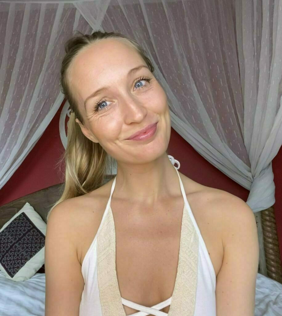 Lua Rose smiling while sitting on a bed