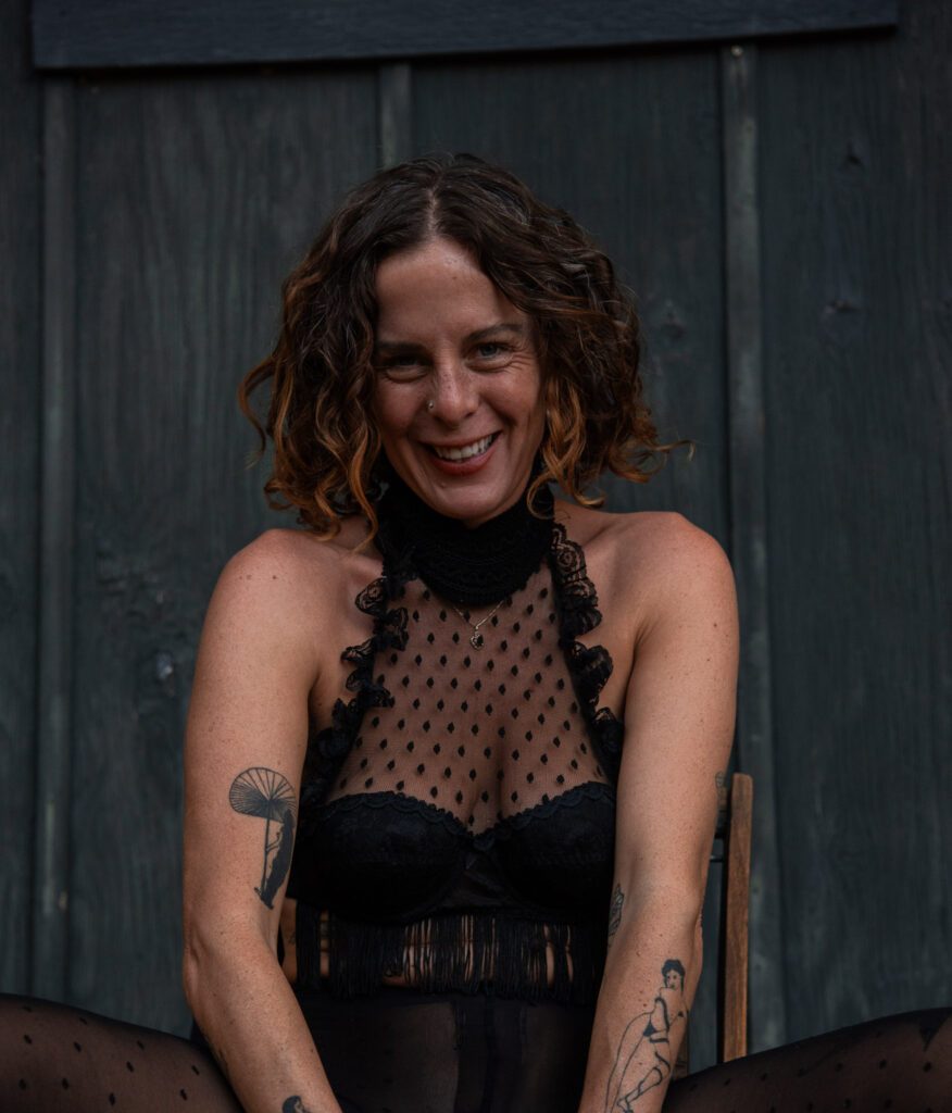 Giggling Calypso in a dark outfit.