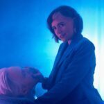 Mistress Em covered in blue with a client