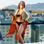 Shot of Ruby standing in the wind on a high balcony.