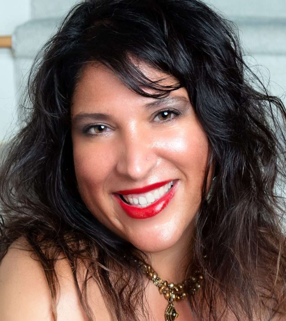 Sacha smiling with big red lips