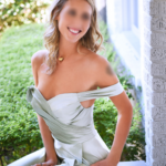 Nova Lily sitting in a silver dress