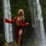 Madi Sun standing in front of a waterfall