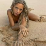 Madi Sun laying in the sand