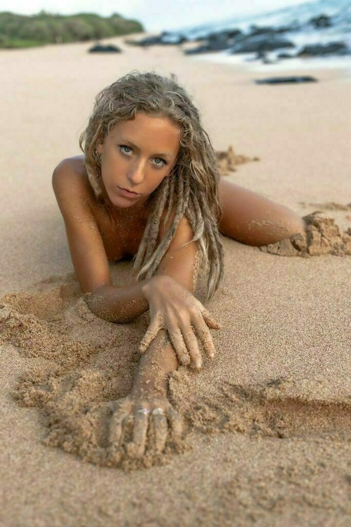 Madi Sun laying in the sand