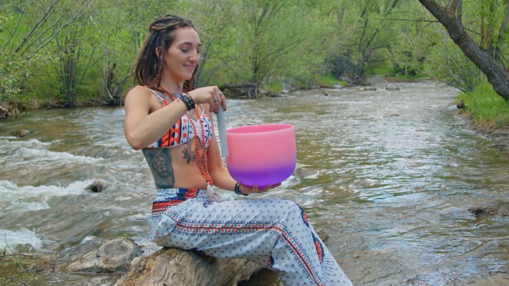 LittleMissMac next to a rivver with a singing bowl