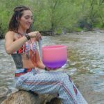 LittleMissMac next to a rivver with a singing bowl
