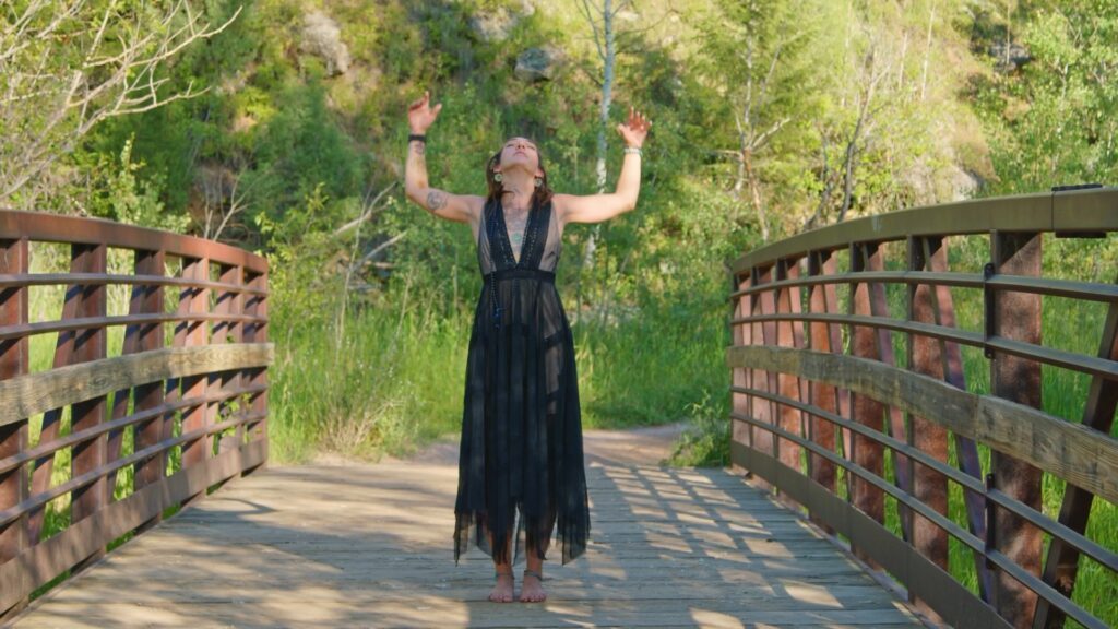 LittleMissMac standing on a bridge