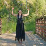 LittleMissMac standing on a bridge