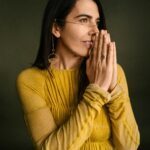 Janelle Marie with her hands in front of her face
